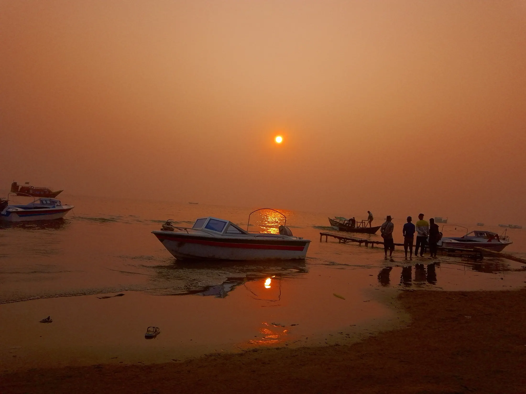 Fishing boats resting in golden morning light at Kuakata